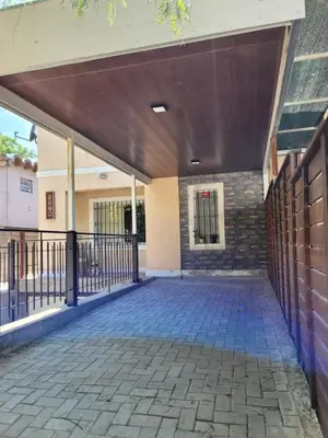 an outdoor patio with awning on a building at Depto Palmar in Villa Carlos Paz