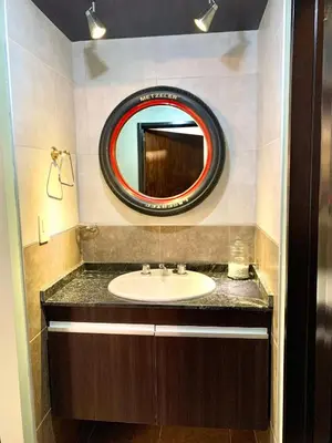 a bathroom with a sink and a mirror at Depto Palmar in Villa Carlos Paz