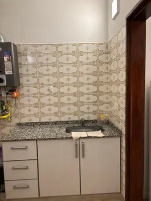 a kitchen with a counter top and a wall at Complejo playa de oro 1 in Villa Carlos Paz