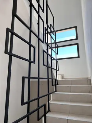 a staircase in a house with black metal railings at Terra Bella Hidromasajes in San Antonio de Arredondo