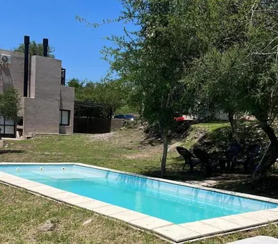 a swimming pool in the yard of a house at Terra Bella Hidromasajes in San Antonio de Arredondo