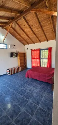 a bedroom with a red bed in a room at Cabaña el fede in Carpintería