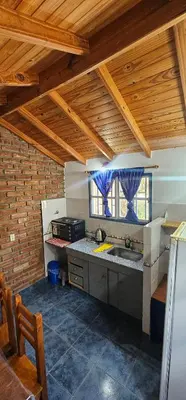 a kitchen with a sink and a counter top at Cabaña el fede in Carpintería