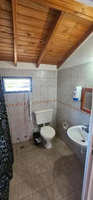 a bathroom with a toilet and a sink at Cabaña el fede in Carpintería