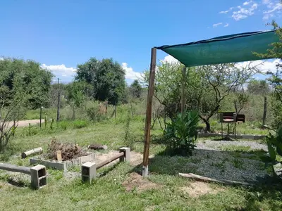 a garden with a tent in a field at Mirador de las Sierras in Villa Parque Siquiman