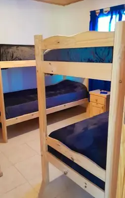 a bedroom with two bunk beds in a room at Mirador de las Sierras in Villa Parque Siquiman