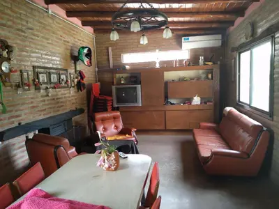a living room with a table and chairs and a couch at Elparadorlasbajadas in Las Bajadas