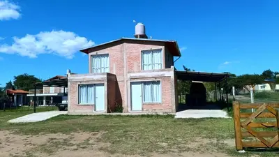 a brick building with a tower on top of it at Cabañas MANKU in San Lorenzo