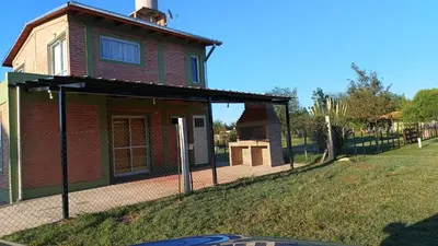 a small house on a chain link fence at Cabañas MANKU in San Lorenzo