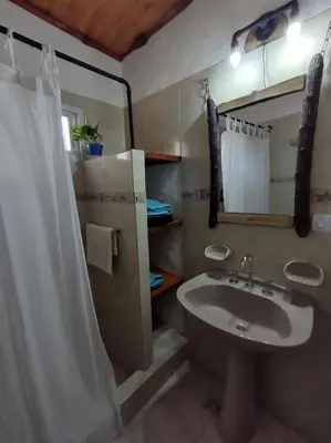 a bathroom with a sink and a shower at Namaste Apart Cabaña in San Francisco del Monte de Oro