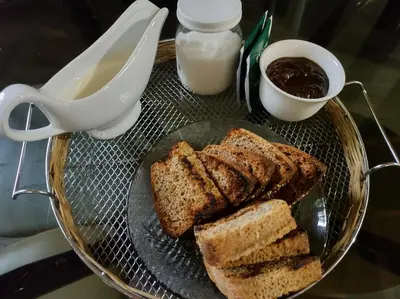 a glass plate with bread and a bowl of milk at Namaste Apart Cabaña in San Francisco del Monte de Oro