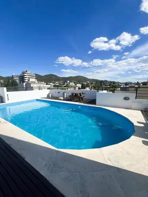 a large blue swimming pool on top of a building at Apart San Jose a 200mts de la peatonal in Villa Carlos Paz