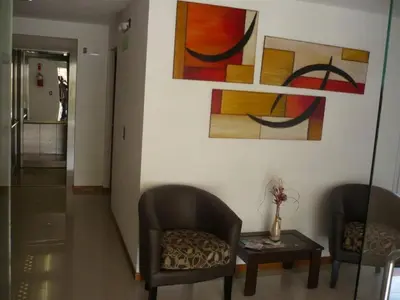 a living room with two chairs and a table at Apart San Jose a 200mts de la peatonal in Villa Carlos Paz
