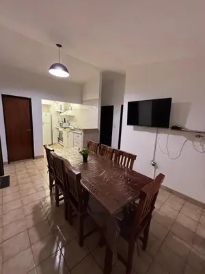 a dining room table and chairs in a kitchen at Complejo playa de oro 2 in Villa Carlos Paz