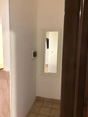 a white room with a mirror and a wall at Complejo playa de oro 2 in Villa Carlos Paz