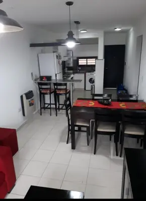 a kitchen and dining room with a table and chairs at Dos Nogales 26 in Villa Carlos Paz