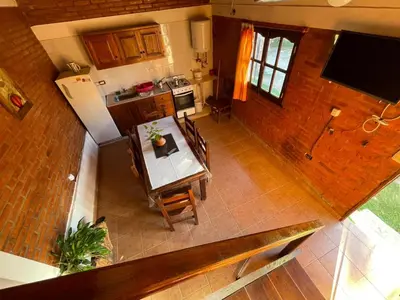 an overhead view of a kitchen with a table and chairs at Cabaña petiza in Mina Clavero