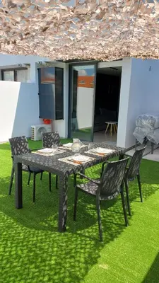 a table and chairs in a yard with a patio at dto 22 TEMPO in Villa Carlos Paz