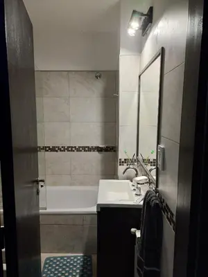 a bathroom with a tub and a sink and a mirror at dto 22 TEMPO in Villa Carlos Paz