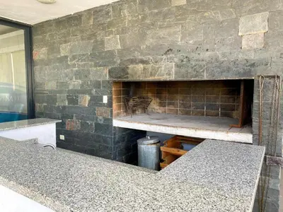 a brick wall with a fireplace in a room at dto 22 TEMPO in Villa Carlos Paz