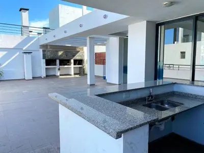 a kitchen counter with a sink in a building at dto 22 TEMPO in Villa Carlos Paz