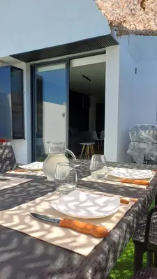 a table with wine glasses and carrots on it at dto 22 TEMPO in Villa Carlos Paz