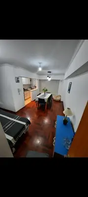a large living room with a table and a kitchen at Depto Lanin 5 in Cordoba