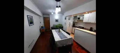 a kitchen with a table in the middle of a room at Depto Lanin 5 in Cordoba