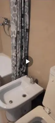 a bathroom with a white sink and a toilet at Depto Lanin 5 in Cordoba