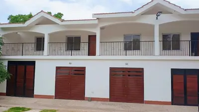 a house with wooden doors and a balcony at Departamentos Elisabeth in Tanti