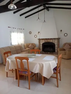 a living room with a table and a fireplace at Departamentos Elisabeth in Tanti