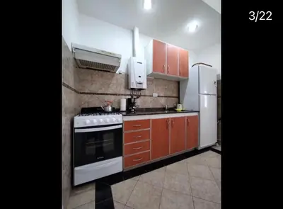a kitchen with a stove and a refrigerator at Departamentos Elisabeth in Tanti