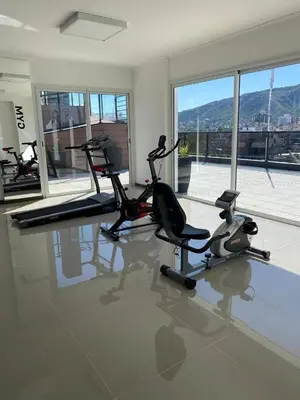a gym with two exercise bikes in a room at Departamento centrico en carlos paz in Villa Carlos Paz