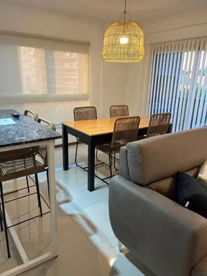 a living room with a table and chairs and a couch at Departamento centrico en carlos paz in Villa Carlos Paz