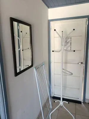 a mirror on a wall next to a white door at Aves Del Monte in Santa Rosa de Calamuchita