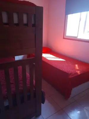 a bedroom with a bunk bed and a window at Aves Del Monte in Santa Rosa de Calamuchita
