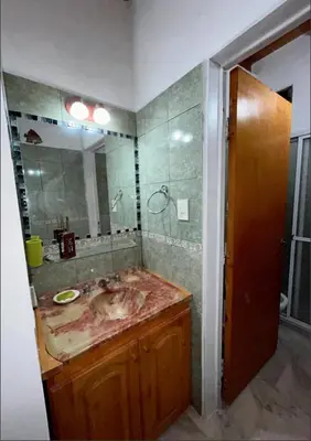 a bathroom with a sink and a large mirror at Departamento de 2 a 5 personas in Villa Carlos Paz