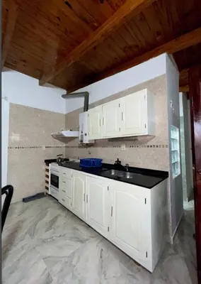 a kitchen with white cabinets and a sink at Departamento de 2 a 5 personas in Villa Carlos Paz