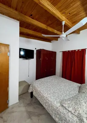 a bedroom with a bed and a ceiling fan at Departamento de 2 a 5 personas in Villa Carlos Paz