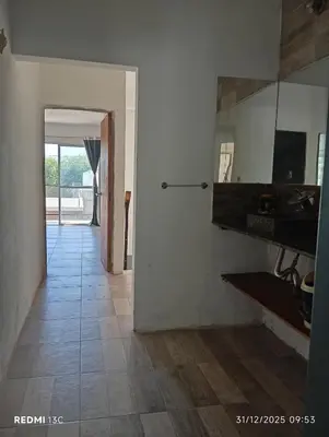 a hallway with a mirror and a tile floor at La Cautivadora Potrero de Garay in Potrero de Garay