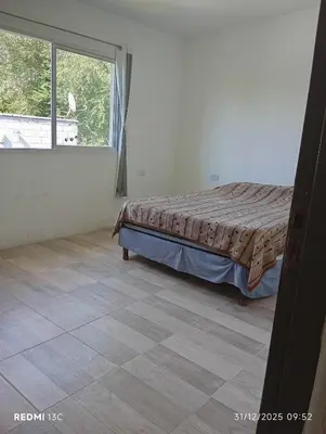 a bedroom with a bed and a window at La Cautivadora Potrero de Garay in Potrero de Garay
