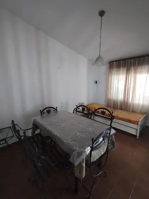 a room with a bed and a table and chairs at Casa con Pileta, solo para familias in Villa Carlos Paz
