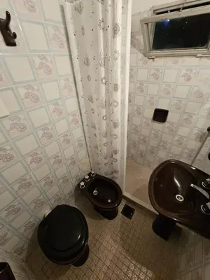 a bathroom with a toilet and a sink at 165saavedra in Villa Carlos Paz