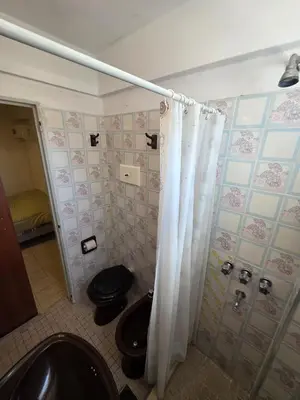 a bathroom with a toilet and a shower curtain at 165saavedra in Villa Carlos Paz
