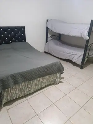 a bedroom with two beds and a tiled floor at Soles in Cordoba