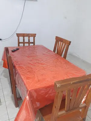 two chairs and a table with an orange table cloth at Soles in Cordoba