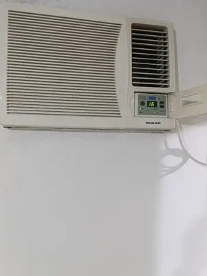 a white air conditioner sitting on top of a wall at Soles in Cordoba