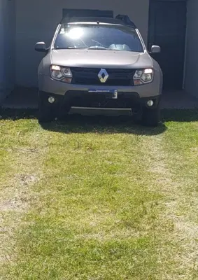 a silver car parked in a yard with grass at Soles in Cordoba