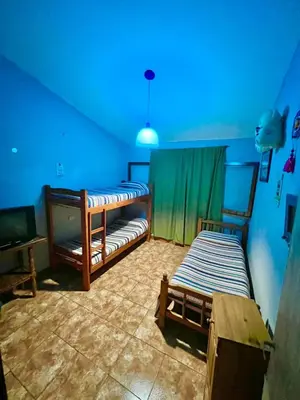 a room with two beds and a blue ceiling at La roca in Villa Carlos Paz