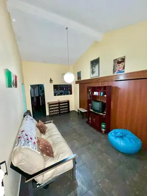 a living room with a couch and a tv at La roca in Villa Carlos Paz
